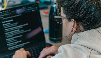 a marketer coding a web page section using AI